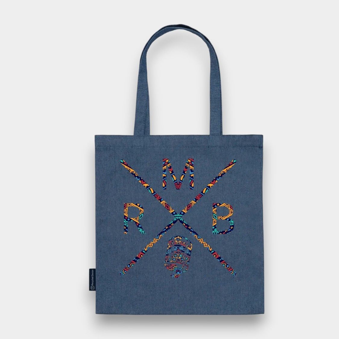 Blue tote bag with colorful patterned lettering and crossed lines design.
